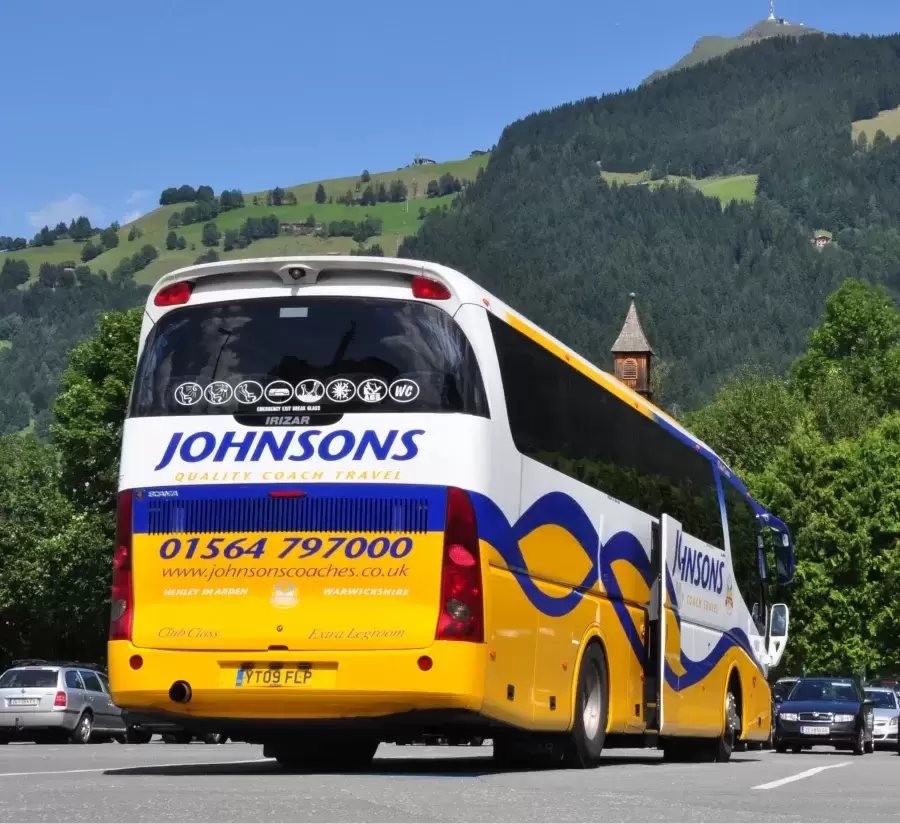 Coach behind mountains